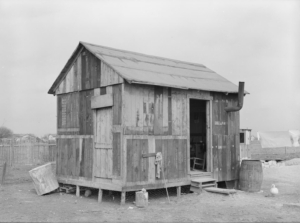 House in Mexican section made of discarded airplane engine crates. San Antonio, Texas. 1939.